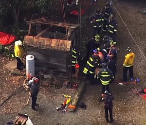 A crew of first responders are shown saving Ernest Silva from a 100-year-old well. (Photo/YouTube)