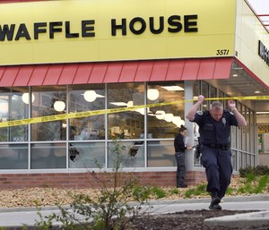Law enforcement officials work the scene of a fatal shooting at a Waffle House.