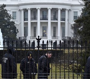 Secret Service officers search the south grounds of the White House in Washington, Monday, Jan. 26, 2015.