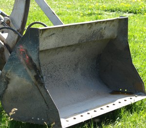 Nebraska police say a man drove his friend to the hospital in the bucket of a stolen loader Friday.