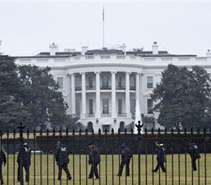 In this Jan. 26, 2015 file photo, Secret Service officers search the south grounds of the White House in Washington after an unmanned aerial drone was found on the White House grounds.