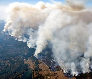 Smoke rises as a wildfire burns in the hills north east of Napa, Calif. (Michael Short/San Francisco Chronicle via AP)
