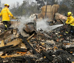 Firefighters douse hot spots in the Coffey Park area of Santa Rosa, Calif.