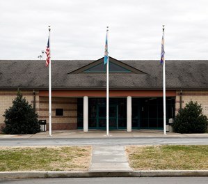 This Dec. 22, 2017, file photo shows the front entrance of the James T. Vaughn Correctional Center in Smyrna, Del. Delaware taxpayers have shelled out more than $360,000 in legal defense costs for 18 prisoners charged in a deadly prison riot last year - and the bills will continue to pile up as the trials get under way. (AP Photo/Patrick Semansky, File)