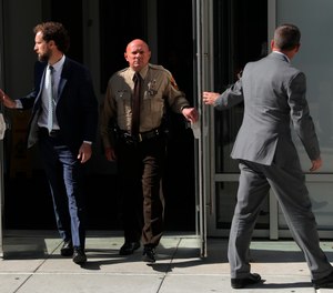 St. Louis County police Sgt. Keith Wildhaber, center, alleges he has been repeatedly passed over for promotions because of his sexual orientation. (Photo/AP)