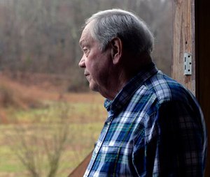 Larry Wilkins speaks with a reporter at his home, Saturday, Jan. 3, 2015, in Kuttawa, Ky. A 7-year-old girl, the lone survivor of a plane crash near his home, walked approximately three quarters of a mile through heavily overgrown woods to Wilkins' home, where he called for assistance.