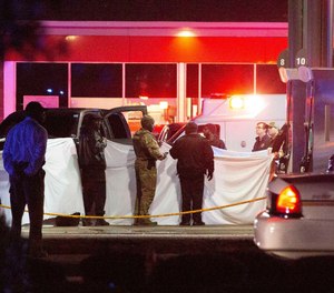 Deputies, police, and state law enforcement work the scene of a QV gas station in Hayneville, Ala., where Lowndes County Sheriff John Williams was shot and killed Saturday night. (Photo/AP)