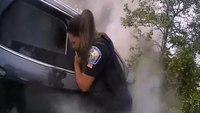 Watch: Fla. officers break window to save man trapped inside burning car