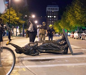 Demonstrators toppled a statue in Madison, Wisconsin June 23 after a night of violent disturbances.