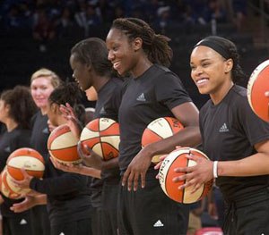 In this Wednesday, July 13, 2016 file photo, members of the New York Liberty basketball team await the start of a game against the Atlanta Dream, in New York.
