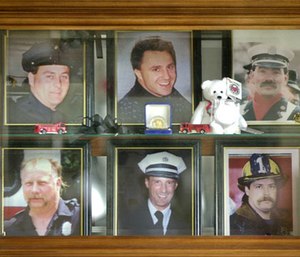 In this 2001 file photo, a display case in the lobby of the Worcester Fire Department Grove Street station memorializes six firefighters who were killed at the cold storage warehouse fire Dec. 3, 1999, in Worcester, Mass. (AP Photo/Charles Krupa, File)