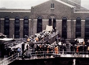 In this Sept. 13, 1971 file photo, correctional officers and New York State troopers gather outside Attica State Prison as they prepare to enter the prison and retake it after inmates rioted and held the prison for five days, in Attica, N.Y.