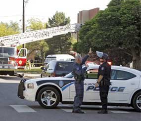 Police block the road in front of an apartment where the suspect in a theatre shooting lived in Aurora, Colo.