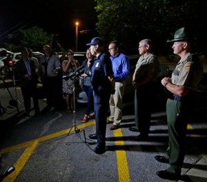 Tennessee Bureau of Investigation Director Mark Gwyn, center, speaks during a news conference held at a truck stop Thursday, June 15, 2017, in Christiana, Tenn.