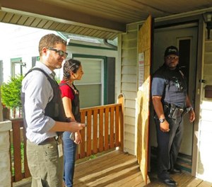 Milwaukee prosecutor Jeremy Arn, left, Safe & Sound coordinator Claudia Pizano, center, and police officer Chauncey Harris prepare to enter a vacant home on the city's north side after neighbors expressed concern about possible criminal activity.