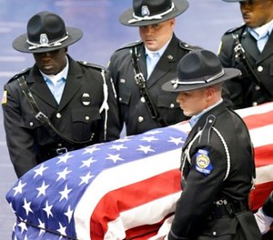 Members of the Georgia Department of Corrections carry the body of corrections officer Sgt. Curtis Billue out of the Wilkinson County High School gymnasium after funeral services Saturday, June 17, 2017 in McIntyre, Ga.