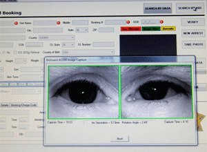 Scans of an inmate's eyes appear on a computer monitor attached to an identification system scanner on Feb. 24, 2010 at the Story County Jail in Nevada, Iowa.