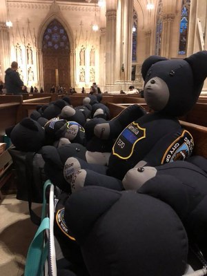 In this photo, bears line a pew at St. Patrick Cathedral in New York City. The family traveled to the city to deliver bears to the NYPD. (Photo/Blue Line Bears)