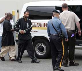 Lorenzo White, facing camera, and two other members of the Bloods street gang set are escorted into a Monmouth County, N.J. Sheriff's van to be transported to Monmouth County Jail in Freehold from State Police Troop B Headquarters in Totowa, N.J. (AP Photo)