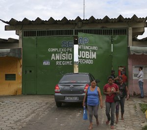 Relatives of prisoners wait to know the names of inmates who died in a prison riot, outside Anisio Jobim Penitentiary Complex in Manaus, Brazil, Tuesday, Jan. 3, 2017.