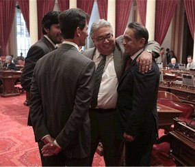 Assemblyman Gil Cedillo, D-Los Angeles, right, is congratulated by Senators Ron Calderon, D-Monterey Park, second from right, Mark Leno, D-San Francisco, third from right, and Kevin de Leon, D-Los Angeles, left, after the Senate approved his measure to allow illegal immigrants in California to get state drivers licenses, at the Capitol in Sacramento, Calif., Wednesday, Aug. 29 2012. (AP Photo/Rich Pedroncelli)