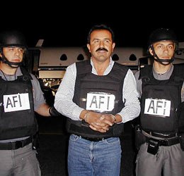 Federal officers escort accused drug cartel leader Miguel Angel Caro Quintero Thursday, Dec. 20, 2001, for extradition to the U.S. (AP Photo/Procuraduria General de la Republica)