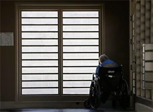 In this July 24, 2014 file photo, an inmate sits by a window at the mental health unit at the California Department of Corrections and Rehabilitation's Stockton Health Facility in Stockton, Calif. (AP Photo/Rich Pedroncelli, file)