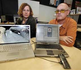 Brett Stalbaum, University of California-San Diego Lecturer with Security of Employment, right, and Micha Cardenas, also a UCSD lecturer in visual Arts, display their software emulations for a cell phone application that assist those entering the United States illegally Monday Dec. 14, 2009 in San Diego.