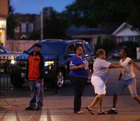 Latayna Herring is held back after she broke down screaming at police near the scene where her 21-year-old son was shot and killed on Aug. 10 in Chicago.