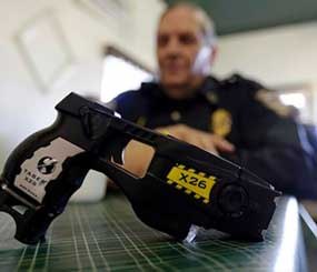 In this Nov. 14, 2013 photo, a Taser X26 is shown as Knightstown Police Chief Danny Baker talks about being shot by the weapon to raise money for his department in Knightstown, Ind.