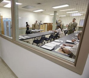 In this photo taken Thursday, Jan. 28, 2016, Rudy Madrigal, left, shares a fist bump with fellow inmate Nicolas Melendrez before Madrigal headed into his world history classroom. (AP Image)