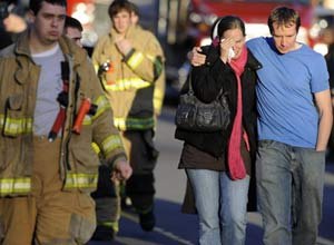 AP PhotoFirefighters and families gather at a staging area following the shooting.