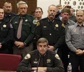 Weld County Sheriff John Cooke, center, backed by a group of fellow sheriffs, testifies against proposed gun control legislation in the Colorado Legislature, at the State Capitol, in Denver, Monday March 4.
