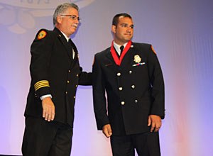 Photo Jamie ThompsonMiami-Dade Firefighter Nicholas DiGiacomo receives the award.
