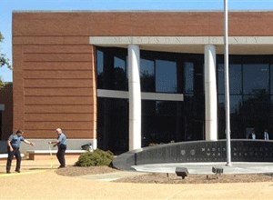 A man fatally shot a defendant waiting in a small courtyard outside a criminal courthouse in Mississippi on Monday morning, and a suspect is in custody, law enforcement officials said.