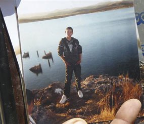An unidentified relative shows a photo of Sergio Adrian Hernandez Huereka, 15, to the press outside his mother's home in the northern border city of Ciudad Juarez, Mexico, Tuesday June 8, 2010. (AP Photo)