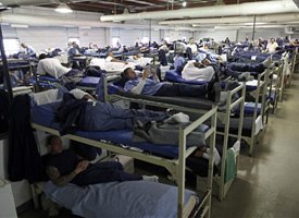 A room full of inmates are seen in their bunk beds at Southeastern Correctional Institution Wednesday, April 22, 2009 in Lancaster, Ohio. Ohio's prisons are at 132 percent capacity and space is squeezing tighter by the day, says prisons director Terry Collins. (AP photo)