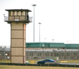 In this Feb. 1, 2017, file photo, a prison guard stands on a tower during a hostage situation at James T. Vaughn Correctional Center in Smyrna, Del. (Suchat Pederson/The News Journal via AP)