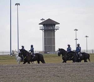 Mounted police patrol travel along Smyrna Landing Road alongside James T. Vaugh Corrections center, Thursday, Feb. 2, 2017 in Smyrna, Del.