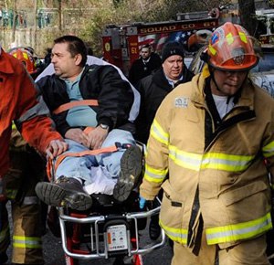 In this Dec. 1, 2013 photo, Metro North Railroad engineer William Rockefeller is wheeled on a stretcher away from the area where the commuter train he was operating derailed in the Bronx borough of New York, killing four and injuring more than 70. A medical document made available April 7, 2014 says he has