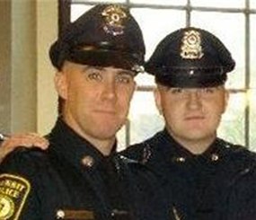 In this 2010 photo provided by the Massachusetts Bay Transportation Authority, Richard Donohue Jr., left, and Sean Collier pose together for a photo at their graduation from the Municipal Police Officers' Academy. (AP Image)