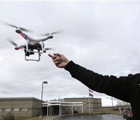 In this Feb. 13, 2014, photo, Jon McBride, who designs and builds drones with Digital Defense Surveillance, flies a training drone for members of the the Box Elder County Sheriff's Office search and rescue team, during a demonstration, in Brigham City, Utah.
