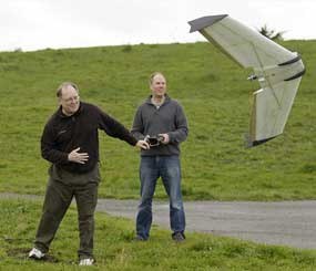 In this March, 28, 2012, photo, Mark Harrison, left, and Andreas Oesterer, right, watch as a Ritewing Zephyr II drone lifts off at a waterfront park in Berkeley, Calif. Interest in the domestic use of drones is surging among public agencies and private citizens alike.