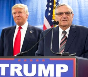 In this Jan. 26, 2016, file photo, then-Republican presidential candidate Donald Trump is joined by Joe Arpaio, the then sheriff of metro Phoenix, during a news conference in Marshalltown, Iowa.