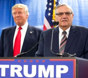 In this Jan. 26, 2016, file photo, then-Republican presidential candidate Donald Trump is joined by Joe Arpaio, the then sheriff of metro Phoenix, during a news conference in Marshalltown, Iowa.