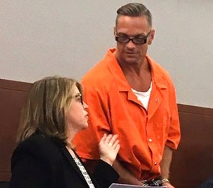 In this Aug. 17, 2017, file photo, Nevada death row inmate Scott Dozier, right, confers with Lori Teicher, a federal public defender involved in his case, during an appearance in Clark County District Court in Las Vegas.