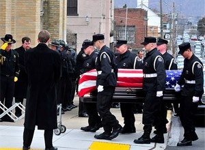 Corrections officers carry the casket of fellow Officer Eric Williams into Holy Trinity Church in Nanticoke, Pa. (AP Photo/The Times Leader, Aimee Dilger, File)