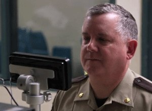 Anoka County jail Cmdr. Dave Pacholl demonstrates how a new iris scanning system works in the release station at the Anoka County Jail. The scan, which is simply a high-quality photograph, takes less time to obtain than fingerprints. (Photo Star Tribune)