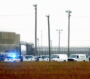 In this Thursday, Oct. 12, 2017 photo, police vehicles are seen outside Pasquotank Correctional Institution in Elizabeth City, N.C. (Thomas J. Turney /The Daily Advance via AP)
