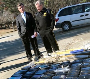 South Carolina Corrections Director Bryan Stirling and Richland County Sheriff Leon Lott talk after a news conference outside Broad River Correctional Institution in Columbia, S.C., Wednesday, Jan. 31, 2018.